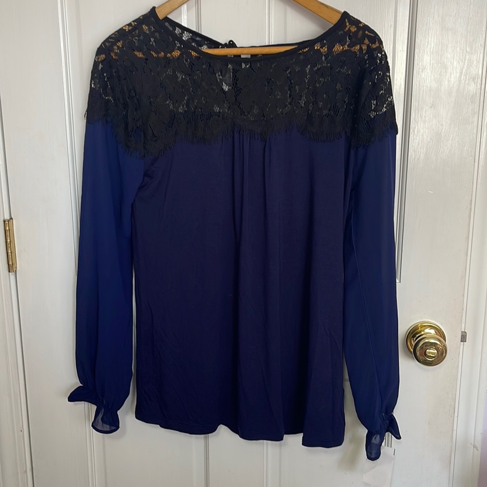 August Silk deep blue top with black lace portion on top. Sleeves shear. Size SM